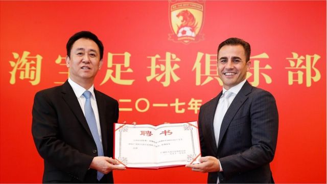 Chairman of Evergrande Group Xu Jiayin (L) and new head coach of Guangzhou Evergrande Fabio Cannavaro pose for photos with the letter of appointment during a press conference on November 9, 2017 in Guangzhou, Guangdong Province of China