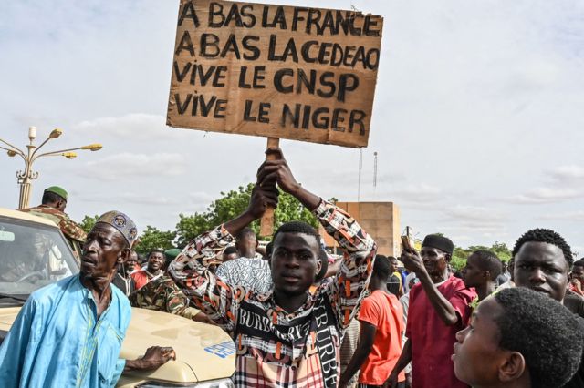 Pro-coup demonstrators holding placards denouncing France and regional body Ecowas