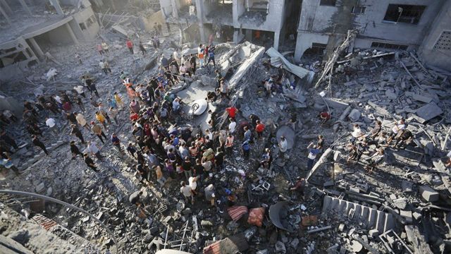 Hombres buscando a sobrevivientes tras un ataque de Israel a Gaza.