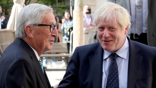 UK Prime Minister Boris Johnson shakes hands with European Commission President Jean-Claude Juncker