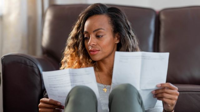 Woman looking at bills