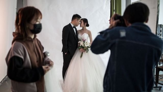 A couple pose for wedding photos at the Pushi wedding photography studioApril 15, 2020 in Wuhan