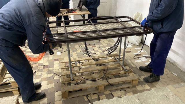 Russian prisoners of war construct outdoor furniture sets