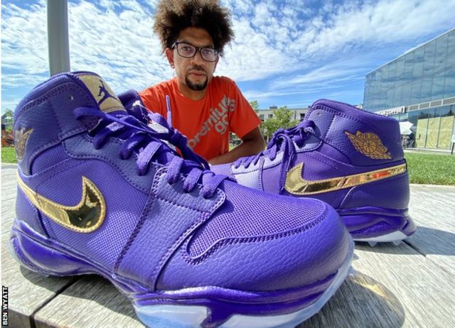 Chad Jones poses with his sneakers