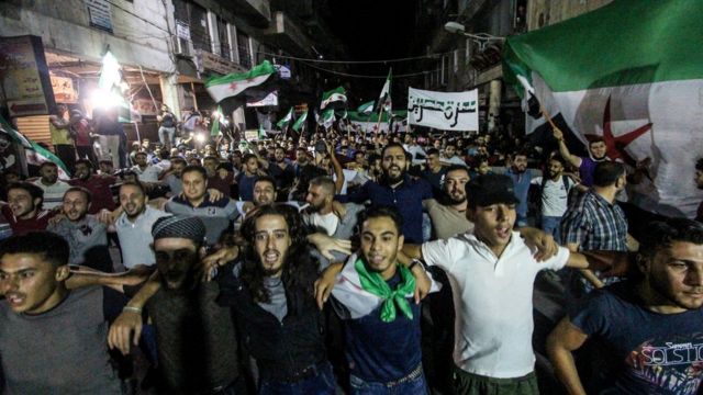 Protesters seen waving the free Syrian flags during an evening demonstration in Idlib City demanding freedom for protocol prisoners imprisoned by the Syrian regime. They are also shouting anti regime slogans and demanding president Assad to step down.