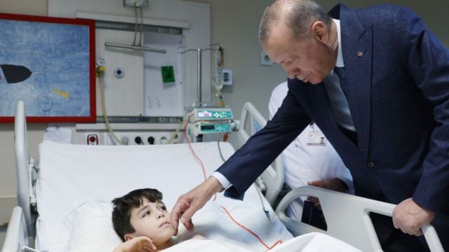 Turkish President Recep Tayyip Erdogan (R) visits quake survivor Aleyna Olmez and other patients receiving treatment at Ankara University Faculty of Medicine Children's Hospital after being transferred from quake-hit regions in Turkey on 22 February 2023