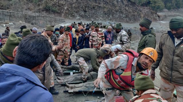 Members of Indo-Tibetan Border Police tend to people rescued after a Himalayan glacier broke and swept away a small hydroelectric dam, in Chormi