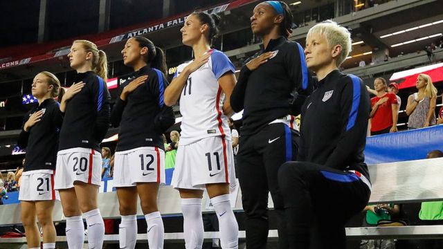 Megan Rapinoe kneels during the US national anthem
