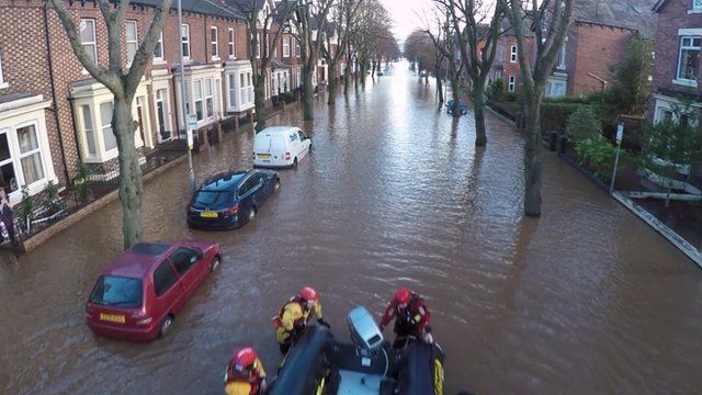 Flooded tree-lined street