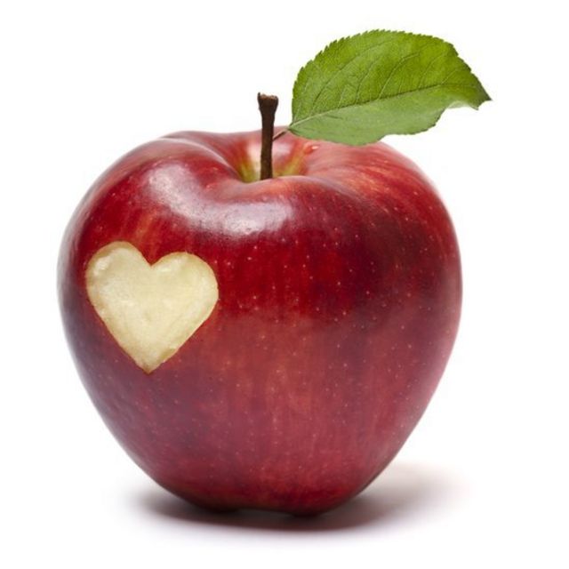 A red apple with a heart shape carved out