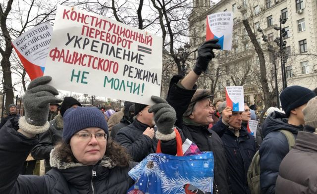 У неколико градова организовани су протести, а овај транспарент упозорава на „рушење уставног поретка", али нису сви Руси толико забринути