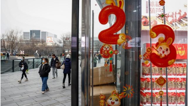 People walk past Lunar New Year decor in China