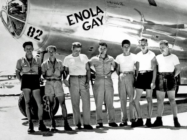 The crew of the bomber Enola Gay pose in front of the aircraft