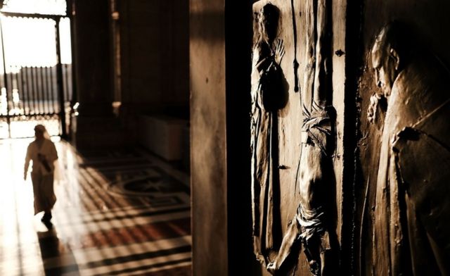 A door to St. Peter's Basilica in the Vatican stands open in the dawn light