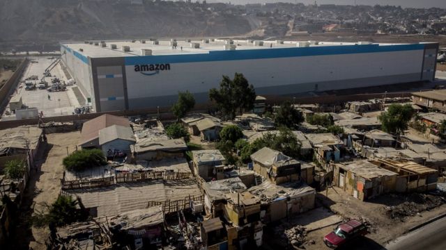 Shacks are seen at an informal settlement next the new Amazon fulfilment centre, which is under construction at the RMSG Alamar Industrial Park, in Tijuana, Mexico September 7, 2021.