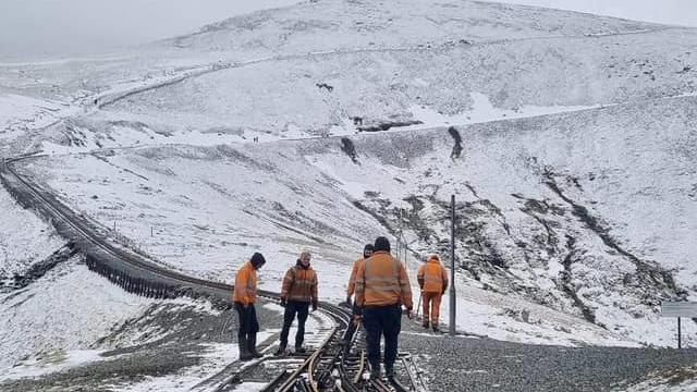 Rail teams work on track on Yr Wyddfa in mid March - with the mountain still covered in snow