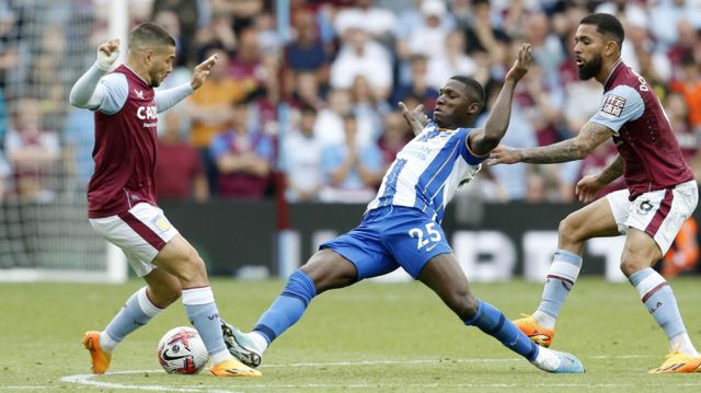Moises Caicedo makes a tackle while playing for Brighton