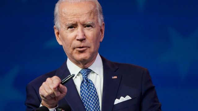 The president-elect of the United States, Joe Biden, a white man with white hair and a serious face