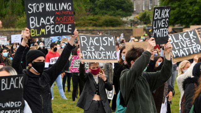 Protesters holds up placards as they attend a demonstration in Edinburgh on 7 June