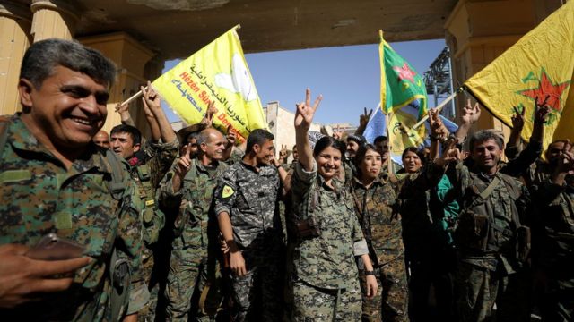 Syrian Democratic Forces fighters celebrate victory against IS militants in Raqqa, Syria, on 17 October 2017