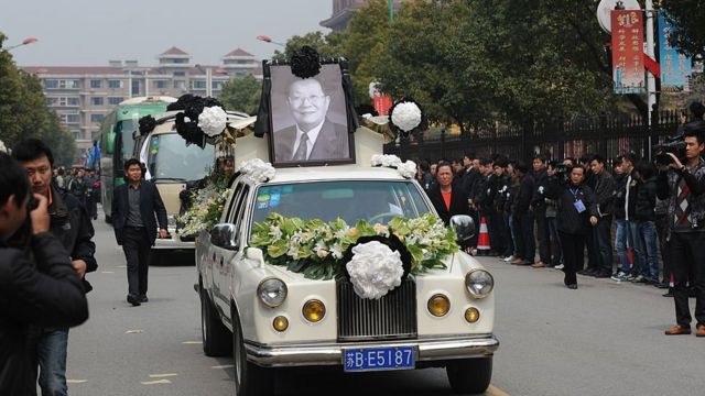 To go with "CHINA-SOCIAL-ECONOMY-POLITICS" story by Bill Savadove The coffin with the body of retired Communist Party chief, Wu Renbao, is driven through the streets of the village of Huaxi on March 22, 2013.