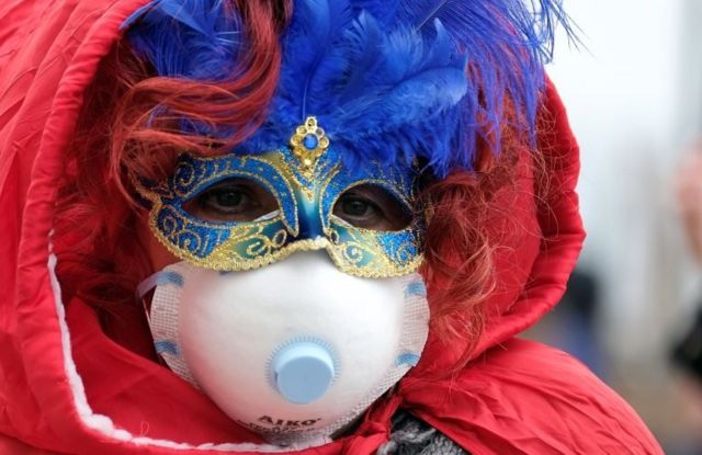 Masked carnival reveller wears protective face mask at Venice Carnival, which the last two days of, as well as Sunday night"s festivities, have been cancelled because of an outbreak of coronavirus, in Venice, Italy February 23, 2020