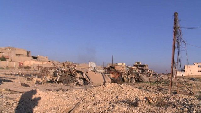 Rubble and damaged buildings and vehicles