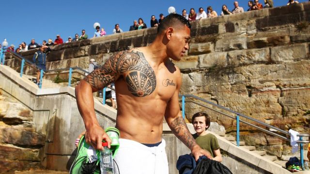Israel Folau of the Wallabies is watched by a crowd during an Australia Wallabies recovery session at Coogee Beach on August 9, 2015 in Sydney, Australia.