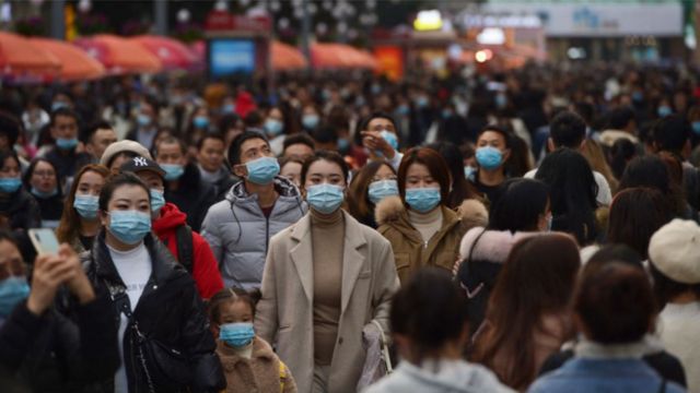 People wearing face masks visit Chunxi Road, the busiest commercial pedestrian Street in Chengdu, on November 28, 2020 in Chengdu, Sichuan Province of China.