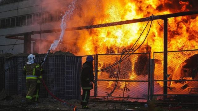 Firefighters extinguish a solar energy facility