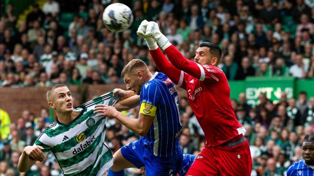 St Johnstone goalkeeper Dimitar Mitov (right) punches clear