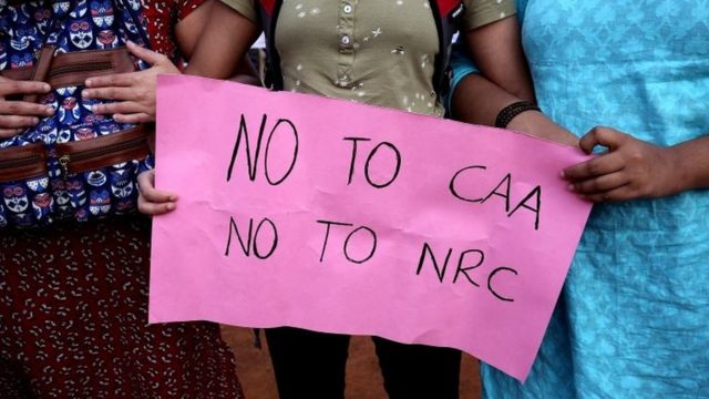 Indian protesters hold sign saying 'No to CAA, No to NRC'