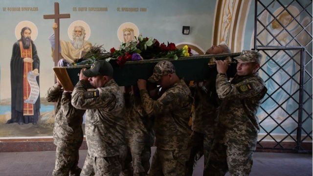 Ukrainian soldiers carrying a coffin