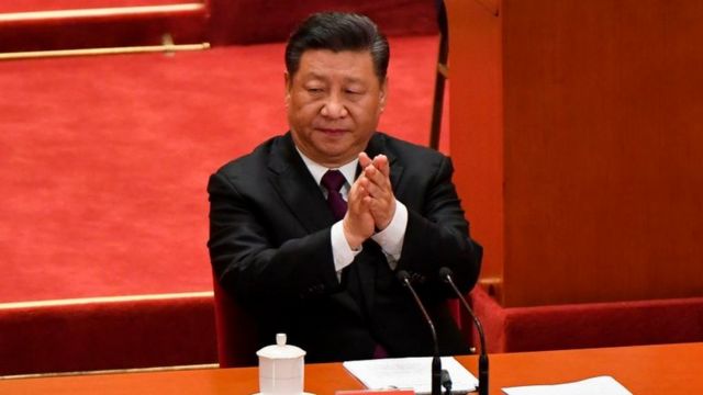 China's President Xi Jinping applauds during a celebration meeting