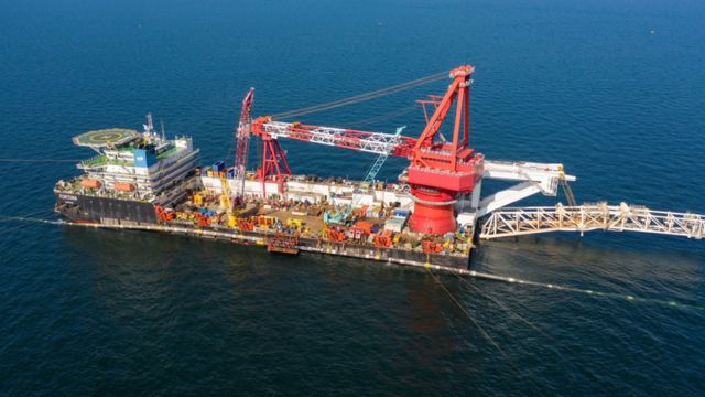 Ship laying pipeline at sea
