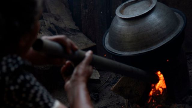 A woman cooks a family lunch using firewood, an alternative to LP gas which is currently in short supply due to the economic crisis in Sri Lanka. January 9, 2022 (Photo by Akila Jayawardana/NurPhoto via Getty Images)