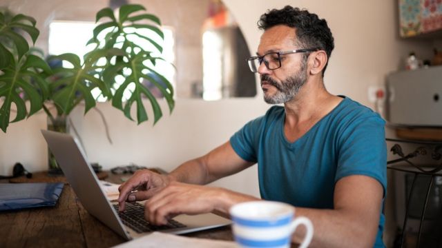 Homem usando laptop para trabalhar em casa