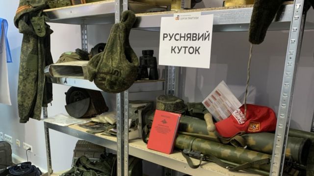 Russian soldiers' equipment on a shelf in a volunteer centre in Kyiv