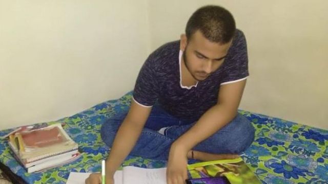 Kumar reading at his home