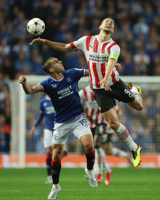 Soccer Football - Champions League Qualifying - Play-off First Leg - Rangers v PSV Eindhoven - Ibrox Stadium, Glasgow, Scotland, Britain - August 16, 2022 Rangers' James Sands in action with PSV Eindhoven's Luuk de Jong Action