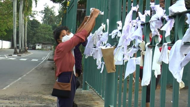 People tying white cloth outside the crematorium