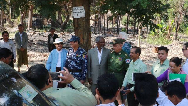 Former UN secretary-general Kofi Annan (C in grey suit), head of a nine-member multi-sector advisory commission on Myanmar"s Rakhine State, is accompanied by local military, police officers and government officials in Wapeik, a burned out Rohingya village in Maungdaw located in Rakhine State near Bangladesh border, on December 3, 2016.
