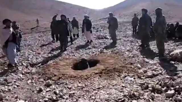 A video frame grab taken from footage recorded on 25 October 2015 - and made available by Radio Free Europe/Radio Liberty - shows men stoning Afghan woman Rokhshana