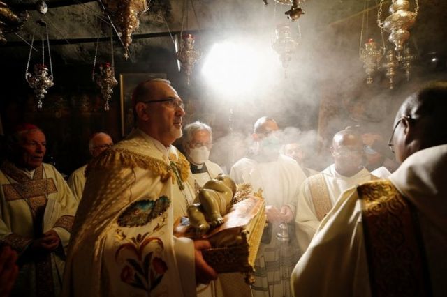 The acting Latin Patriarch of Jerusalem Pierbattista Pizzaballa leads a Christmas midnight Mass at St Catherine's Church, in the Church of the Nativity, in the West Bank Palestinian city of Bethlehem. Photo: 25 December 2021