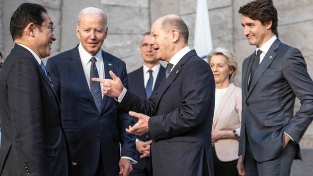 German Chancellor Olaf Scholz (3R) greets Japan's Prime Minister Fumio Kishida (L), US President Joe Biden (2L) next to NATO Secretary General Jens Stoltenberg (3L) and European Commission President Ursula von der Leyen and Canada's Prime Minister Justin Trudeau (R) during a NATO summit at the alliance's headquarters in Brussels on March 24, 2022.