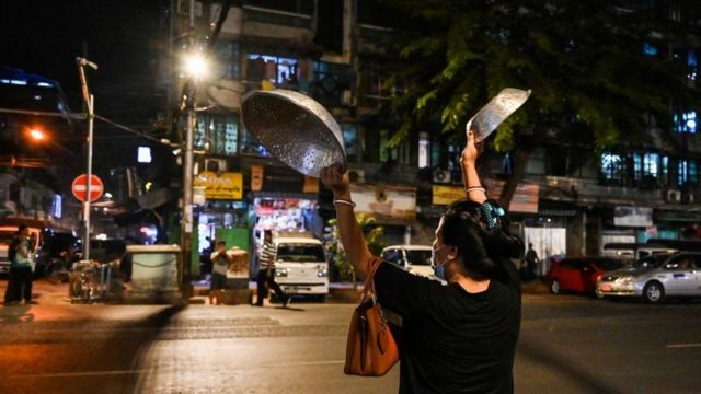 Residents knock down cooking utensils in protest in Yangon on Wednesday