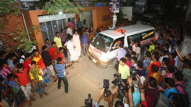 The bodies of two gay rights activists who were hacked to death are brought down from an apartment in Dhaka on April 25, 2016.