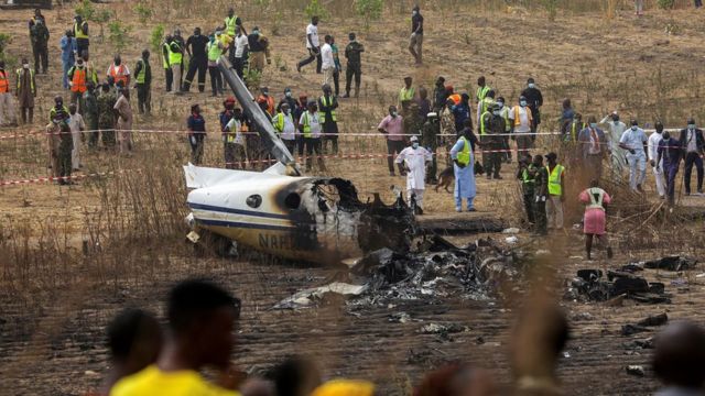 People and rescuers gather at the site where a Nigerian air force plane crashed while approaching the Abuja airport runway, according to the aviation minister, in Abuja, Nigeria February 21, 2021.