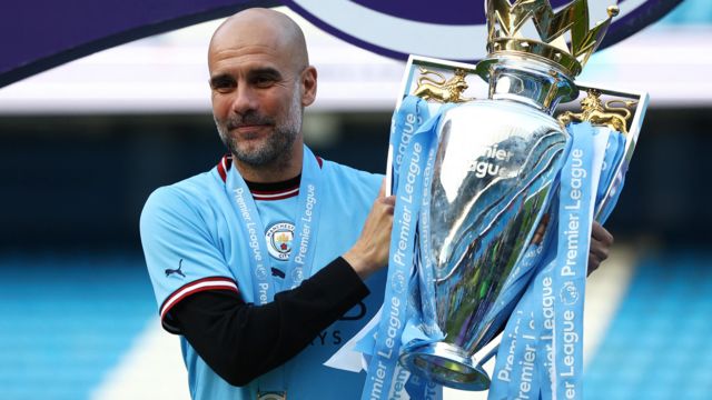 Pep Guardiola with the Premier League trophy