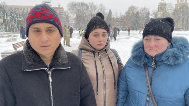 Denys Sosnenko's father, mother and sister pictured at the funeral